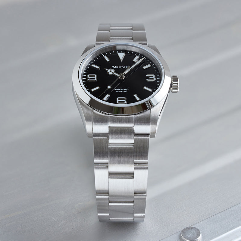 Stainless steel watch standing upright on a table