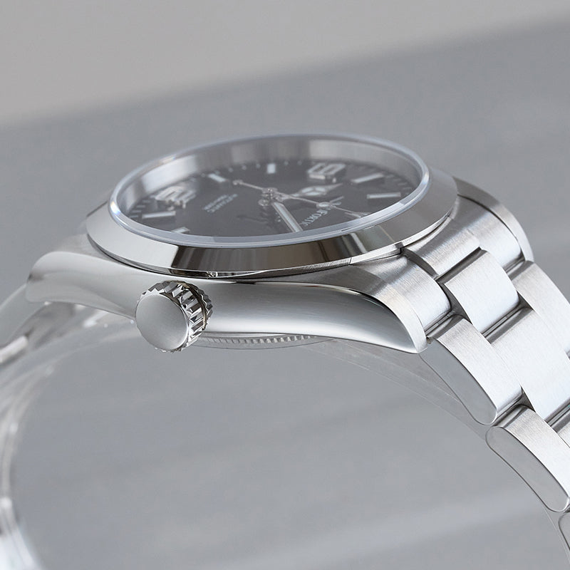 Stainless steel watch, side view, polished upper case, brushed lower case, and brushed strap