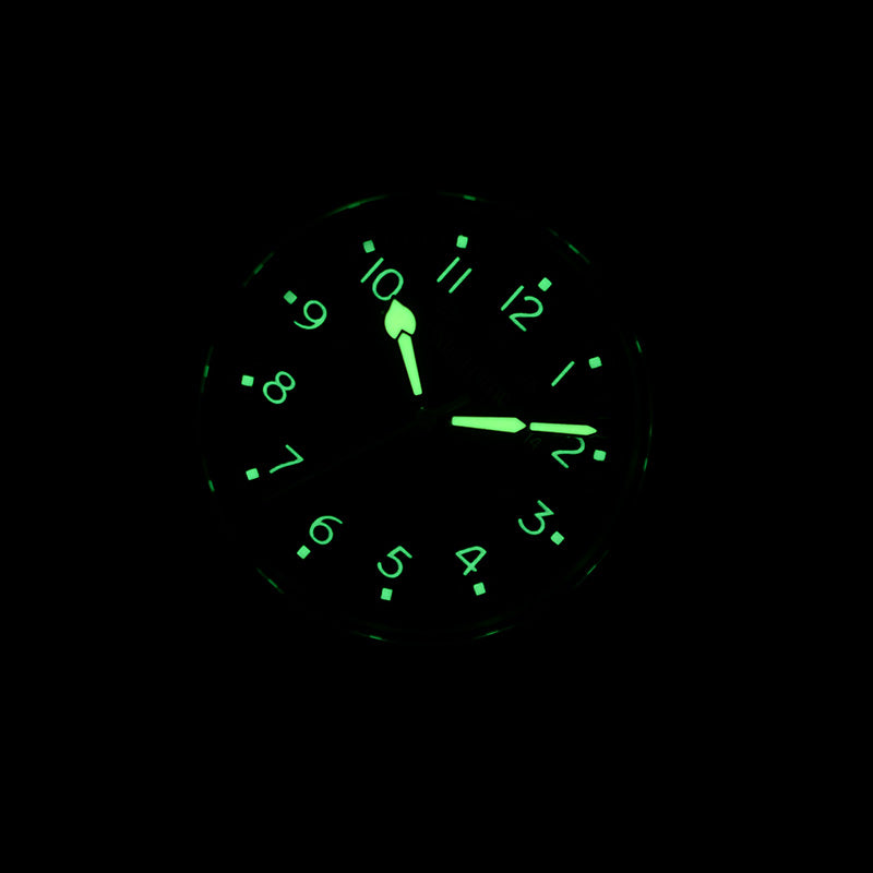 Soft green luminous hands and numbers glowing in the dark