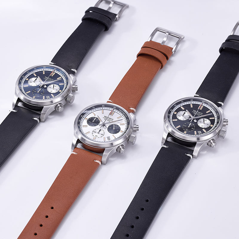 Three chronograph watches in different colors, lying flat on the table