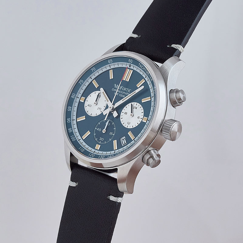 Blue dial chronograph with black leather strap, angled side view