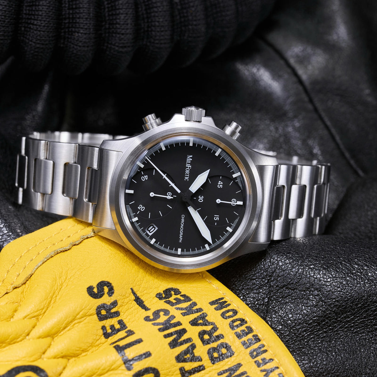 QM39M136 destro chronograph resting on a yellow leather glove